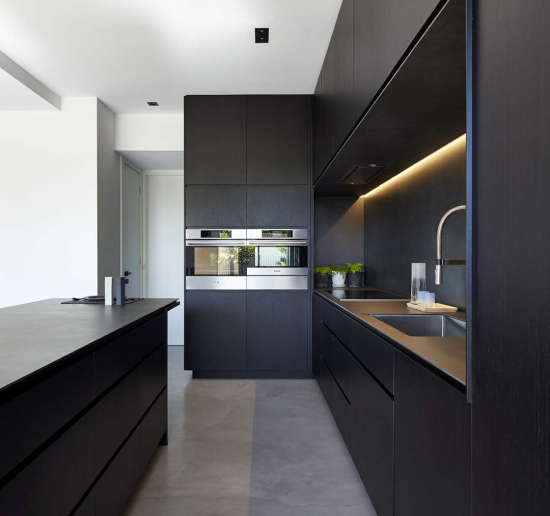 Designer reviewing a custom kitchen layout in the Longo showroom