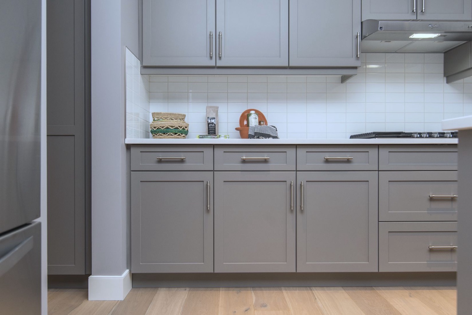Modern kitchen with cabinet drawers open showing internal construction
